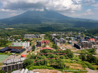 Discover this prime parcel of land offering breathtaking views of a majestic mountain and lush green surroundings.