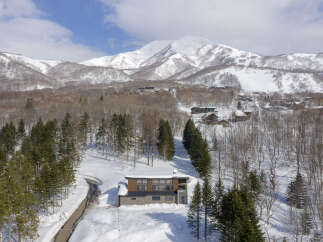 Experience luxury mountain living in this stunning modern home, nestled amidst snow-covered slopes and majestic peaks.