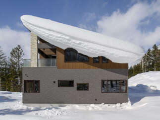 Experience the charm of this modern mountain home, perfectly situated in a snowy landscape.