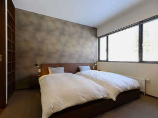 Experience comfort and style in this inviting bedroom featuring two plush beds dressed in crisp white linens.