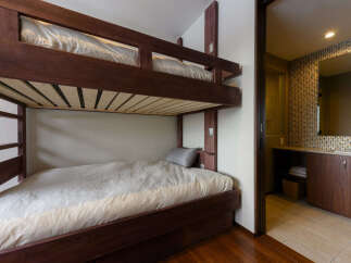This cozy room features a sturdy wooden bunk bed, perfect for families or groups.
