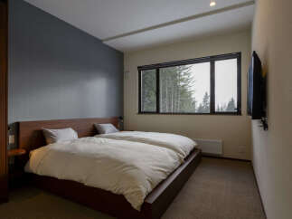 Experience ultimate comfort in this serene bedroom featuring two plush twin beds dressed in crisp white linens.