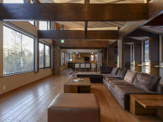 Experience luxurious living in this spacious great room featuring a large sectional sofa and a modern coffee table.