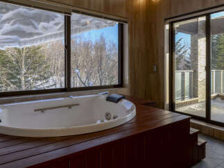 Indulge in ultimate relaxation in this luxurious bathroom featuring a spacious jacuzzi tub.