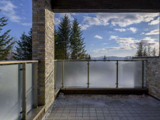 Experience breathtaking mountain views from this stunning balcony, perfect for enjoying crisp, fresh air.