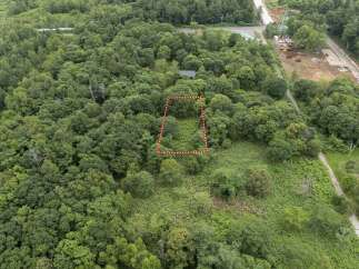 Discover this prime parcel of land nestled within a lush, green forest, offering a serene and private retreat.
