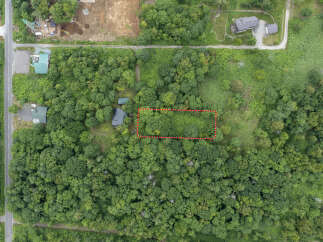 Discover this prime parcel of land, nestled amidst lush greenery and mature trees.