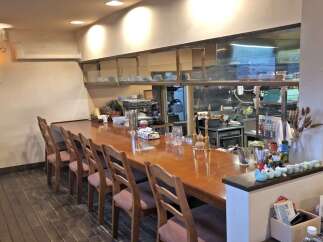 Step into this inviting bar area, featuring a polished wooden counter perfect for enjoying a drink or a meal.