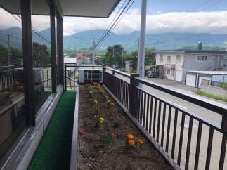 Enjoy scenic mountain views from this charming property's balcony, complete with a flower bed and artificial turf for a touch of greenery.