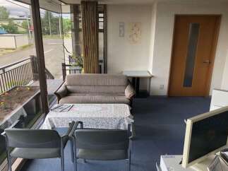 This inviting waiting area features a comfortable sofa and two chairs, perfect for clients or guests.