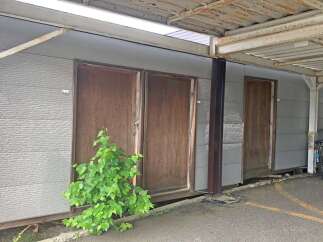 Discover this unique property featuring multiple individual units, each with its own private wooden door.