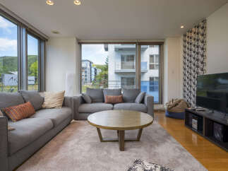 Experience modern living in this spacious living room, featuring a large sectional sofa perfect for relaxation and entertaining.