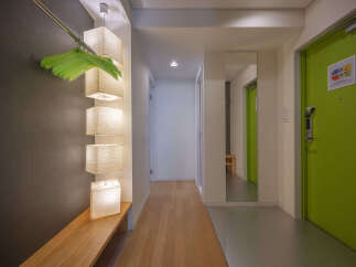 Discover modern living in this hallway featuring a sleek wooden bench and stylish pendant lights.