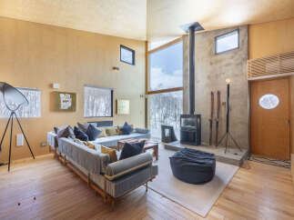 Experience modern living in this stunning property featuring a spacious open-concept living area with a dramatic floor-to-ceiling window offering breathtaking views.