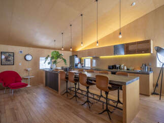 Experience modern living in this stunning kitchen and dining area, featuring a sleek concrete island with comfortable leather bar stools, perfect for entertaining.