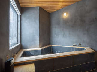 Experience ultimate relaxation in this modern bathroom featuring a unique, angular soaking tub.