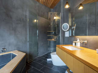 Experience modern luxury in this stunning bathroom featuring a deep soaking tub and a separate glass-enclosed shower.
