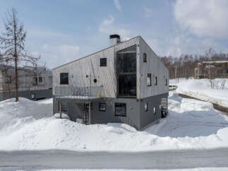 Experience modern living in this architecturally striking home, featuring a unique asymmetrical roofline and a striking facade of natural wood.