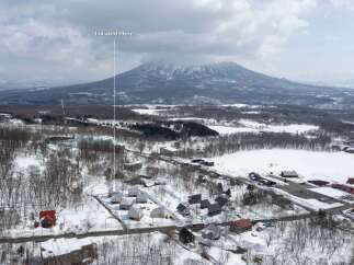 Discover this stunning property nestled amidst a serene winter landscape, offering breathtaking views of a majestic snow-capped mountain.