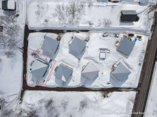 Discover this prime real estate opportunity featuring a collection of modern homes nestled in a serene, snow-covered landscape.