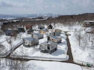 Discover modern architectural marvels nestled in a serene, snow-covered landscape.
