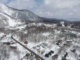 Discover this charming winter wonderland property nestled amidst snow-covered trees and rolling hills.