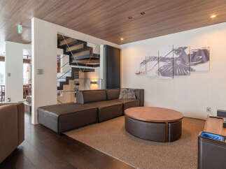 Experience modern living in this stylish apartment featuring a sleek sectional sofa and a unique oval coffee table.