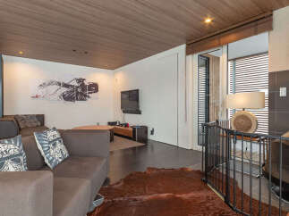Experience modern living in this stylish living room featuring a plush sectional sofa adorned with unique Star Wars-themed pillows.