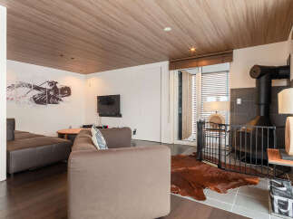 Experience modern living in this stylish living room, featuring a sleek sectional sofa and a striking abstract art piece.