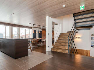 Experience modern living in this spacious open-concept home, featuring a sleek kitchen island and a warm, inviting dining area perfect for gatherings.