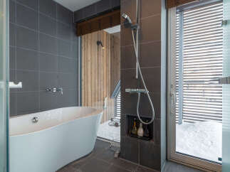 Experience ultimate relaxation in this luxurious bathroom featuring a deep soaking tub and a modern shower.