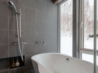 Experience ultimate relaxation in this modern bathroom featuring a luxurious freestanding bathtub.