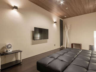 Experience modern comfort in this stylish room featuring a plush, tufted sofa perfect for relaxation.