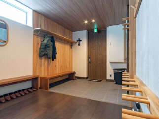 Step into this welcoming entryway featuring warm wooden accents and ample storage.