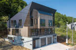 Discover modern living in this multi-story home, featuring a striking combination of wood and metal siding.