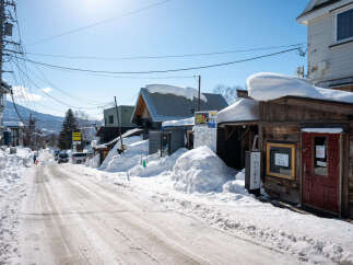 Experience the charm of this snow-covered street, perfect for a cozy winter getaway.