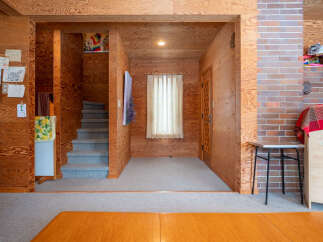 Step into a warm and inviting interior featuring rich wood paneling throughout, creating a cozy and rustic ambiance.