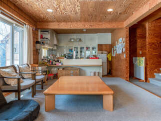Discover this charming living space featuring a warm, wood-paneled interior and a spacious, light-filled room.