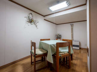 This dining area features a charming wooden table set with four chairs, perfect for intimate meals.