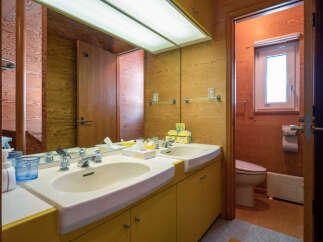 This bathroom features a double vanity with two sinks and ample counter space, perfect for busy mornings.