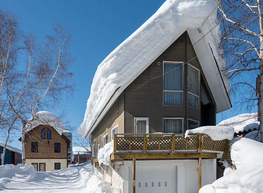 Experience the charm of a winter wonderland with this picturesque property, featuring a cozy home nestled amidst snow-covered landscapes.
