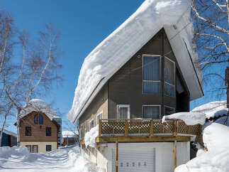 Experience the charm of a winter wonderland with this picturesque property, featuring a cozy home nestled amidst snow-covered landscapes.