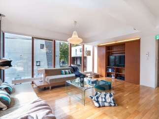 Experience modern living in this spacious apartment featuring a large living area with floor-to-ceiling windows offering abundant natural light.