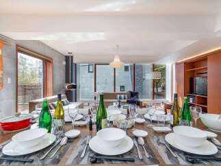 Experience elegant dining in this modern home, featuring a beautifully set table ready for guests.