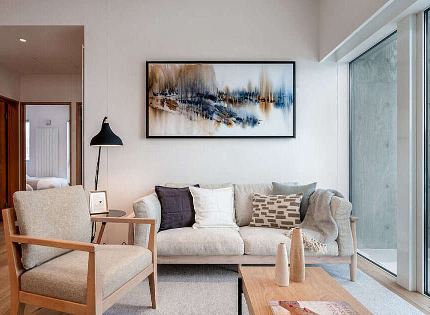 Experience modern living in this beautifully appointed living room, featuring a comfortable sofa and armchair perfect for relaxation.