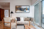 Experience modern living in this beautifully appointed living room, featuring a comfortable sofa and armchair perfect for relaxation.