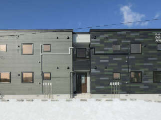 Discover modern living in this stylish apartment building, featuring a unique facade with a mix of grey and green patterned siding.