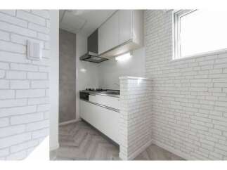 Discover this charming kitchen featuring a modern white brick backsplash and sleek white cabinetry.