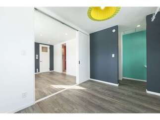 Discover modern living in this stylish apartment featuring a sleek open-plan layout with a sliding door for flexible space division.
