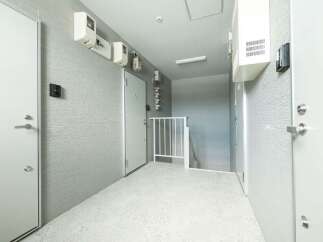 Discover modern living in this hallway featuring sleek white doors and textured grey walls.